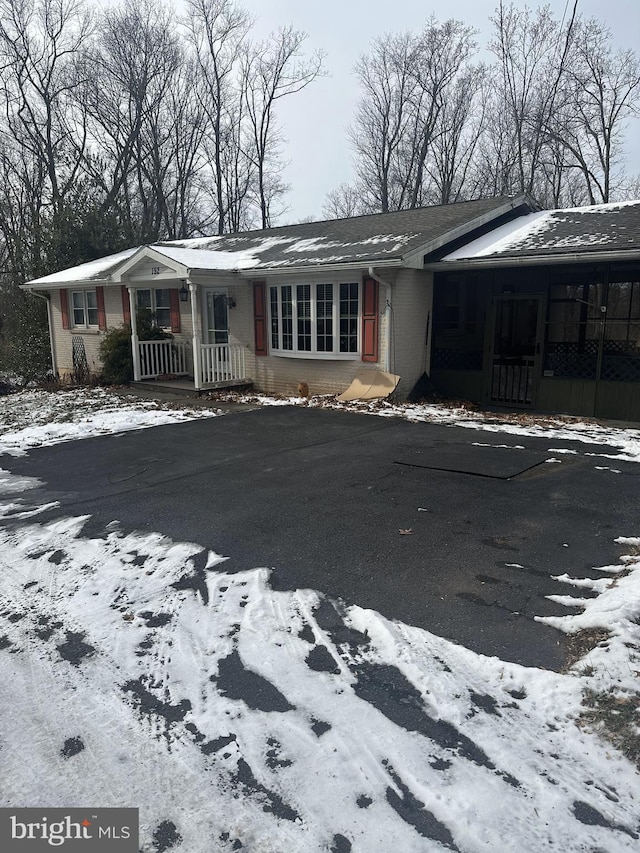 view of snow covered back of property