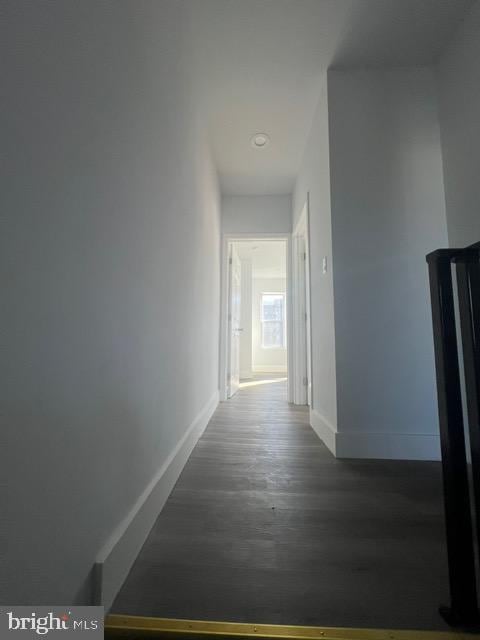 hallway with dark wood-type flooring