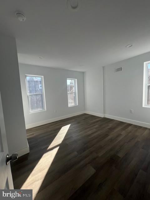 spare room with dark hardwood / wood-style floors