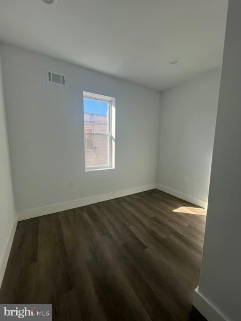 empty room featuring dark hardwood / wood-style flooring