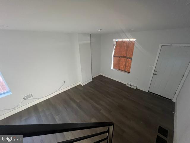 spare room with dark wood-type flooring