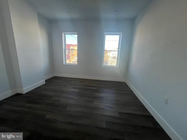 unfurnished room with dark hardwood / wood-style floors