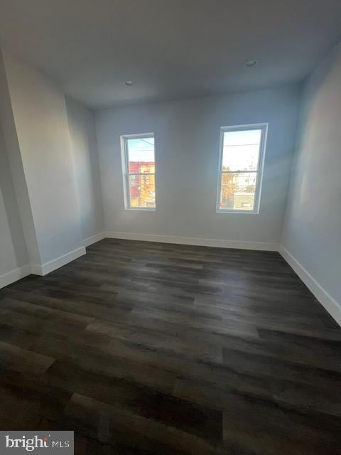 empty room featuring dark hardwood / wood-style flooring