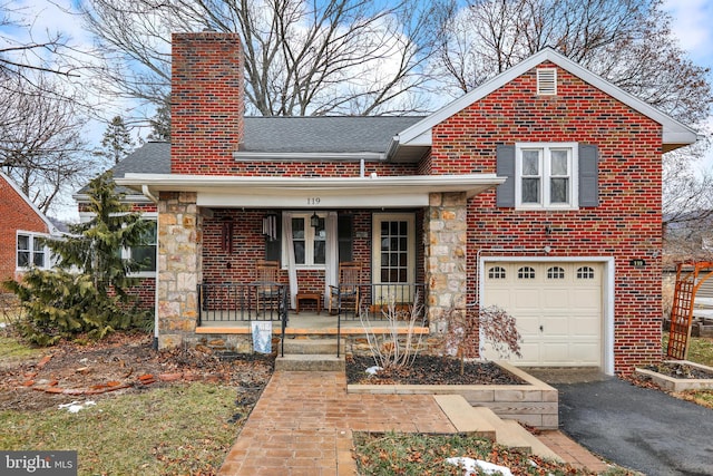 view of front of home with a garage and covered porch