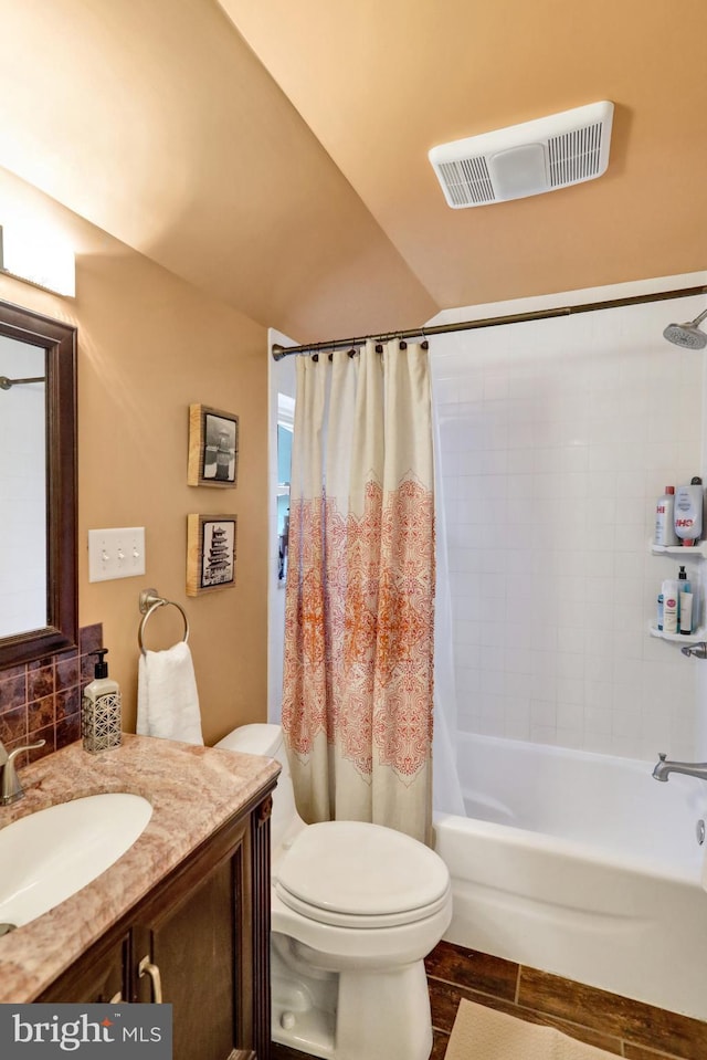 full bathroom featuring vanity, toilet, and shower / tub combo with curtain