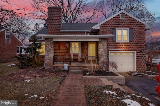 view of front facade with covered porch and a garage