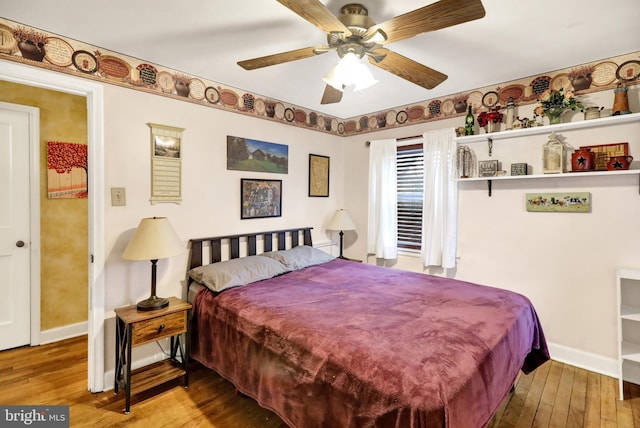 bedroom with hardwood / wood-style flooring and ceiling fan