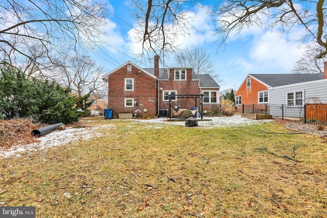 rear view of property featuring a lawn