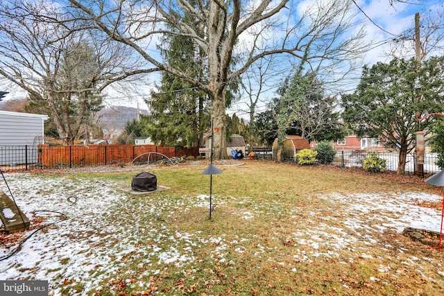 yard covered in snow with a mountain view