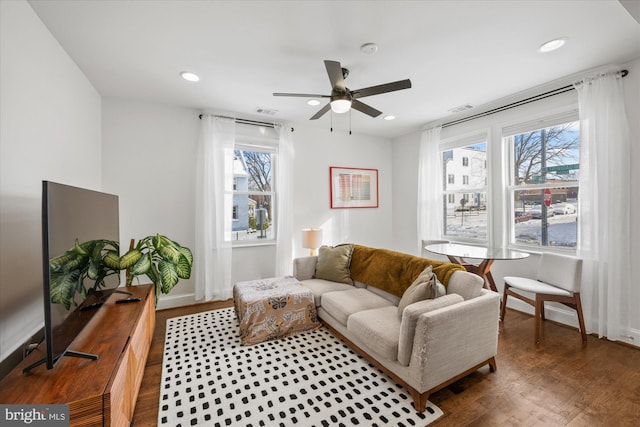 living room with ceiling fan, plenty of natural light, and hardwood / wood-style flooring