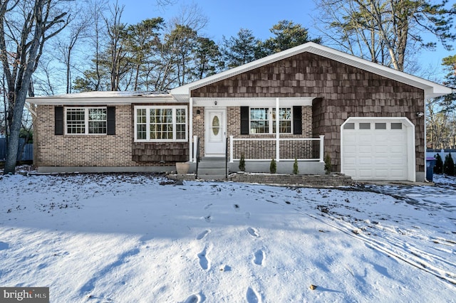 ranch-style house featuring covered porch and a garage