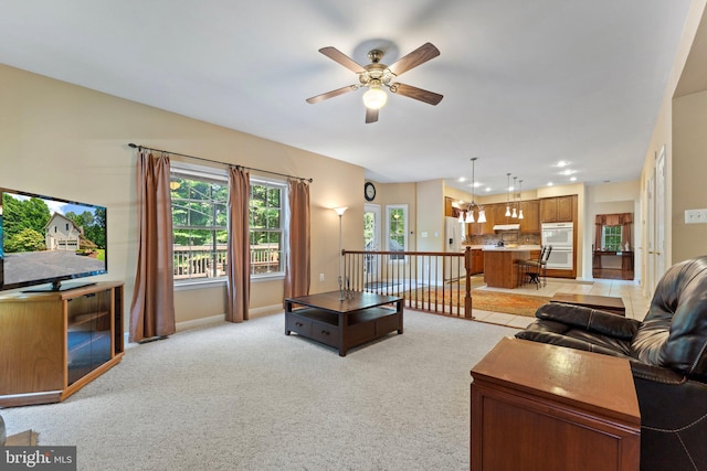 living room featuring ceiling fan and light carpet