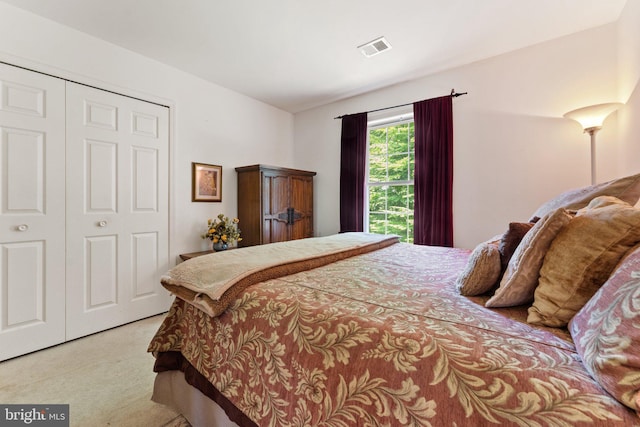 bedroom with light carpet and a closet