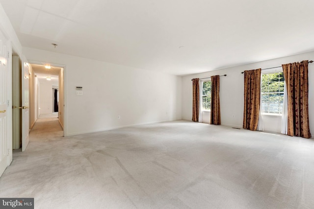 unfurnished room featuring light carpet