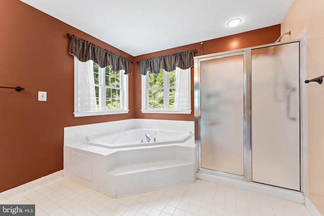 bathroom featuring separate shower and tub