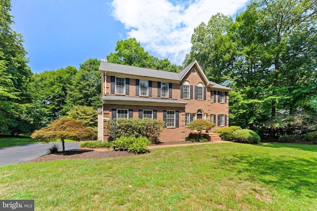 colonial-style house with a front lawn