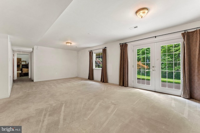 carpeted spare room with french doors