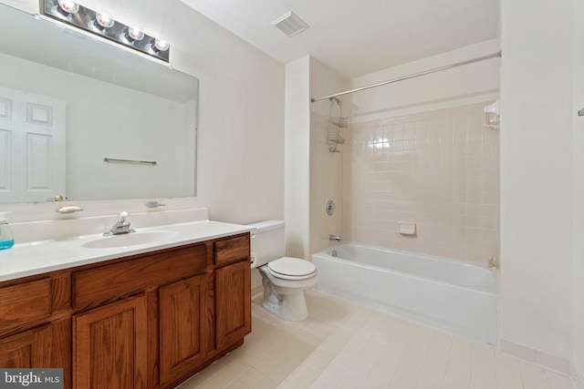 full bathroom with tiled shower / bath combo, toilet, and vanity