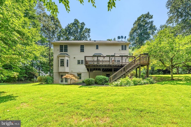 rear view of house featuring a yard and a wooden deck