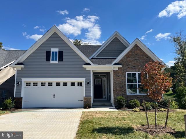 craftsman-style house with a front yard and a garage