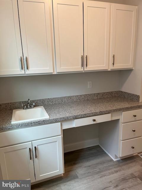 interior space featuring sink and light hardwood / wood-style flooring