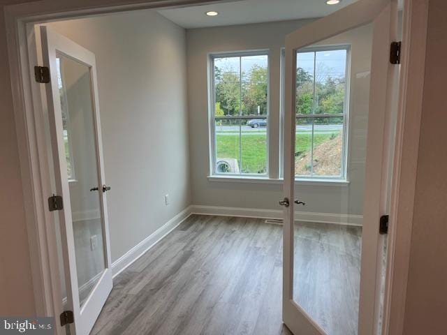 doorway to outside featuring french doors and light wood-type flooring