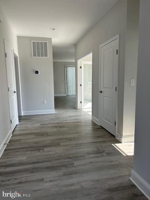 hallway featuring dark hardwood / wood-style flooring