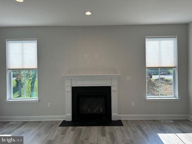 unfurnished living room featuring dark hardwood / wood-style floors