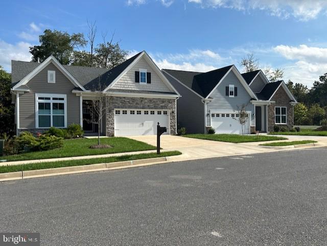 view of front of house with a front yard and a garage