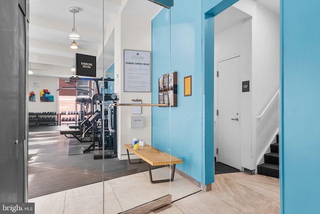 hall with tile patterned floors