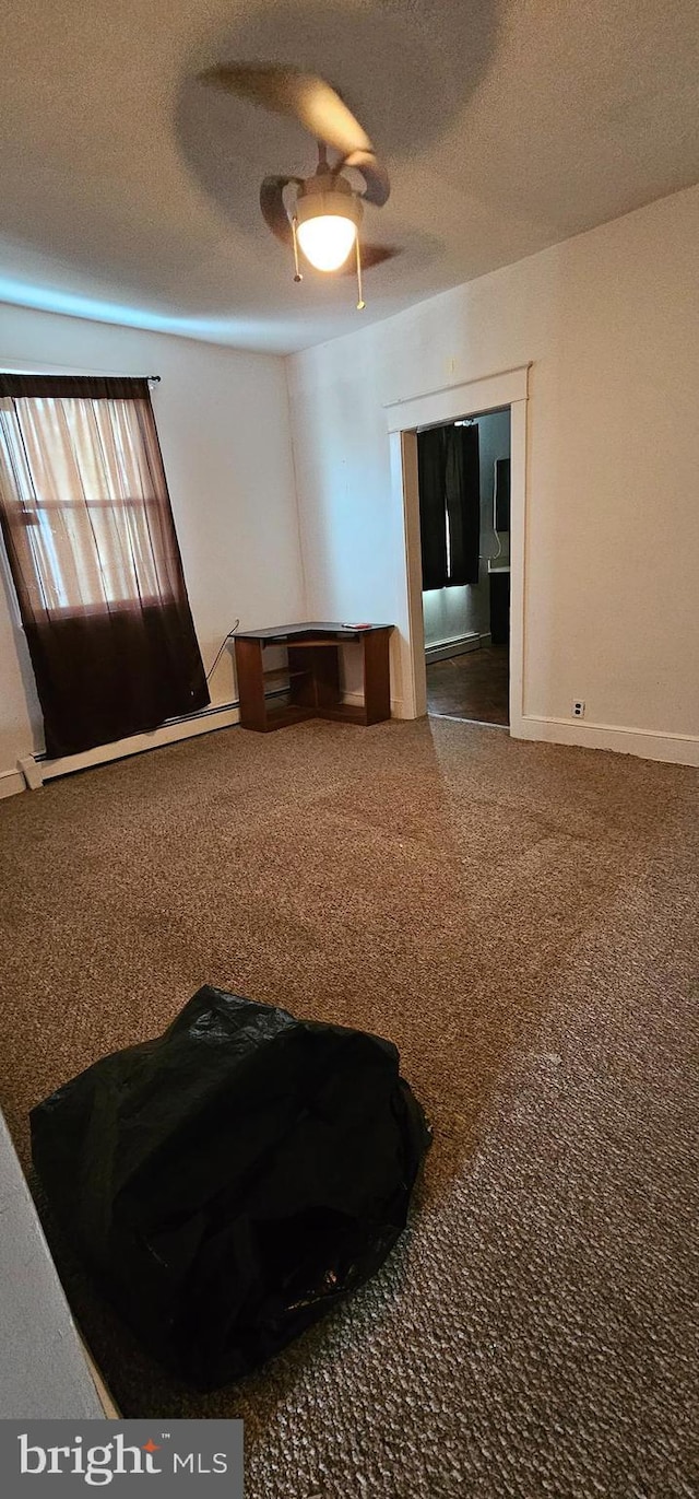 miscellaneous room with ceiling fan and a textured ceiling