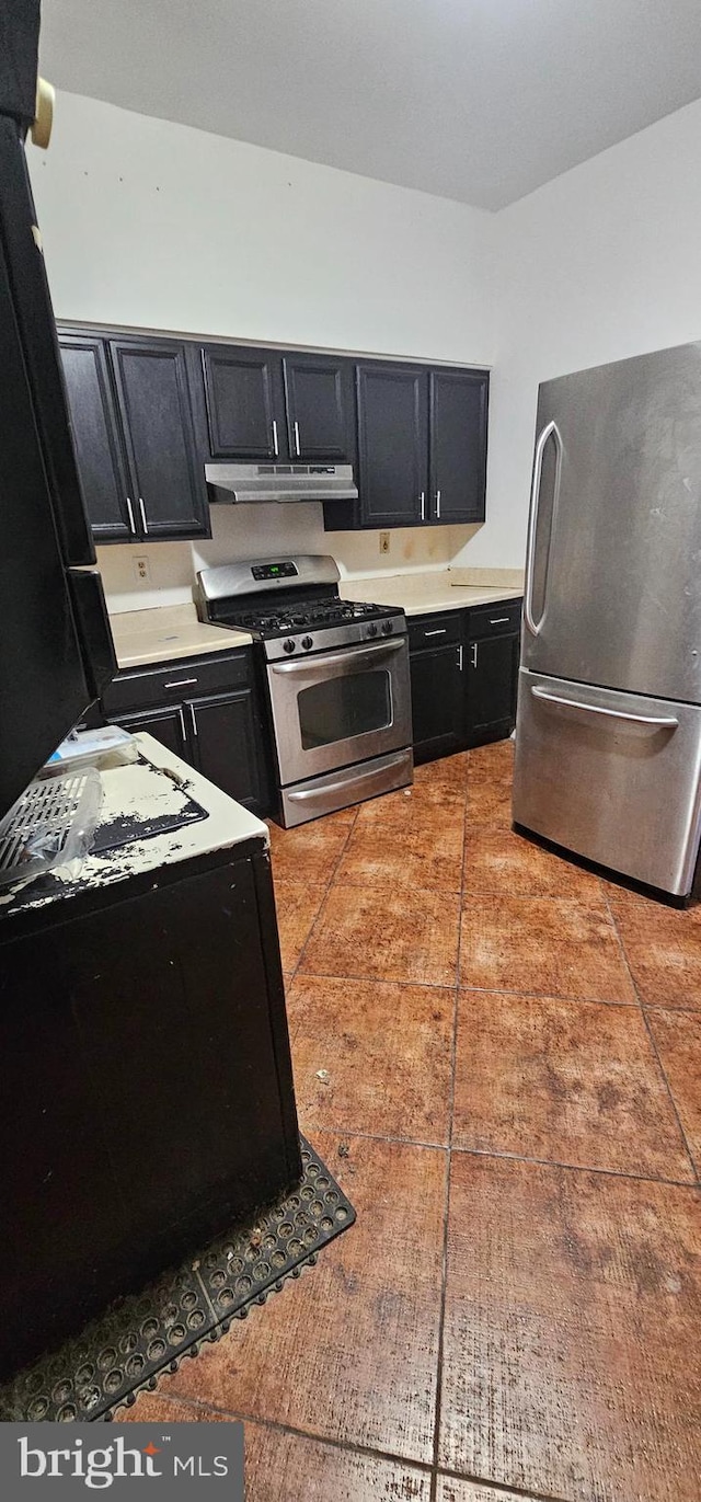 kitchen with light tile patterned flooring and appliances with stainless steel finishes