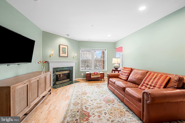 living room featuring light hardwood / wood-style floors and a fireplace