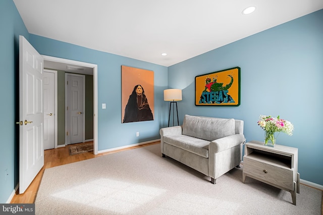 sitting room with wood-type flooring