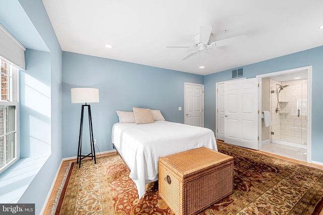 bedroom with ceiling fan and connected bathroom