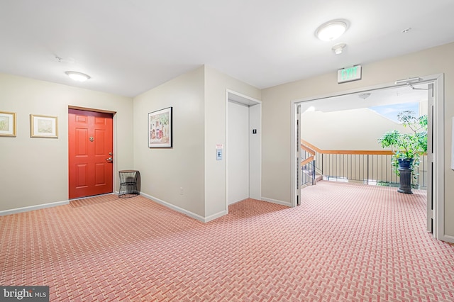 corridor with carpet and elevator