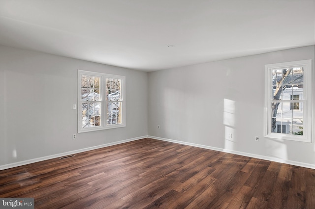 unfurnished room featuring dark wood-type flooring