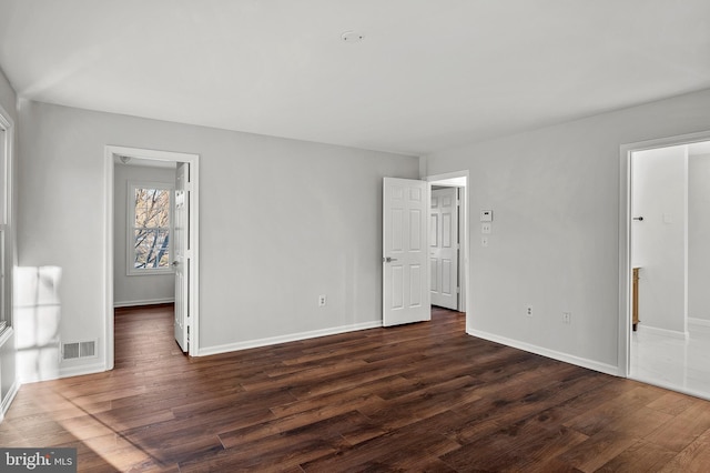 empty room with dark wood-type flooring