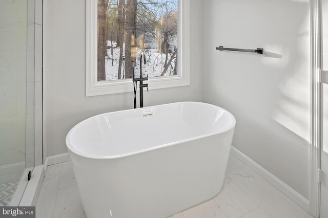 bathroom with a tub to relax in