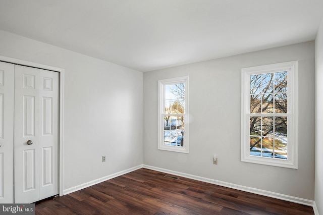 unfurnished bedroom featuring dark wood-type flooring