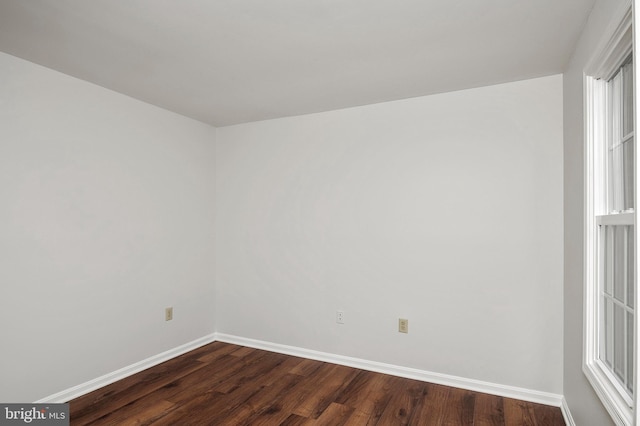 empty room with dark wood-type flooring