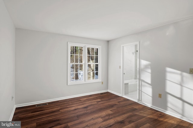 empty room with dark hardwood / wood-style floors