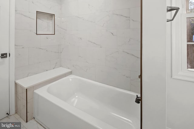 bathroom with a tub to relax in