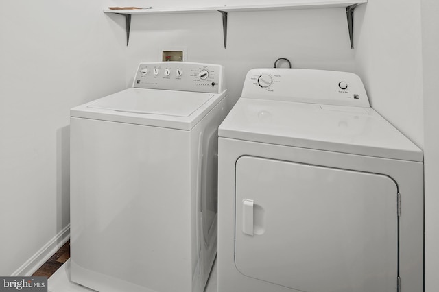 clothes washing area featuring independent washer and dryer