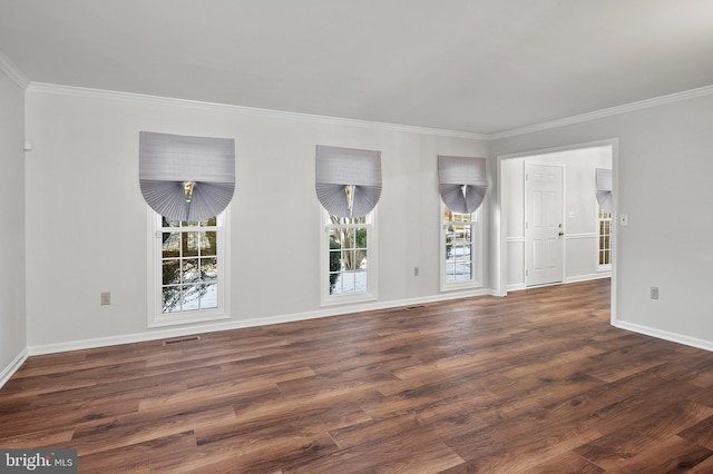 empty room with ornamental molding and dark hardwood / wood-style flooring