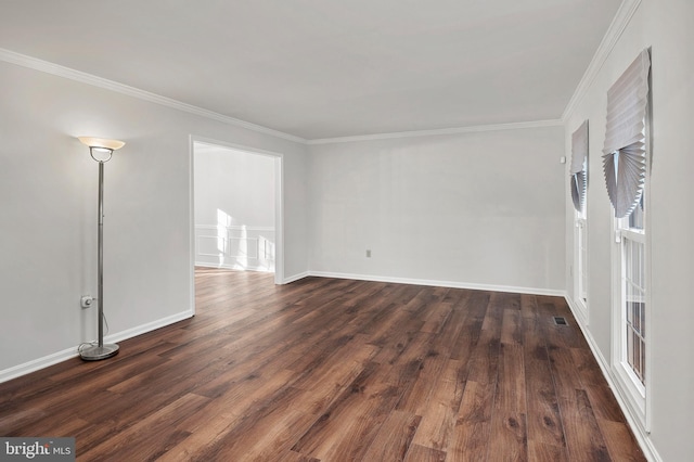 spare room featuring dark hardwood / wood-style flooring and ornamental molding