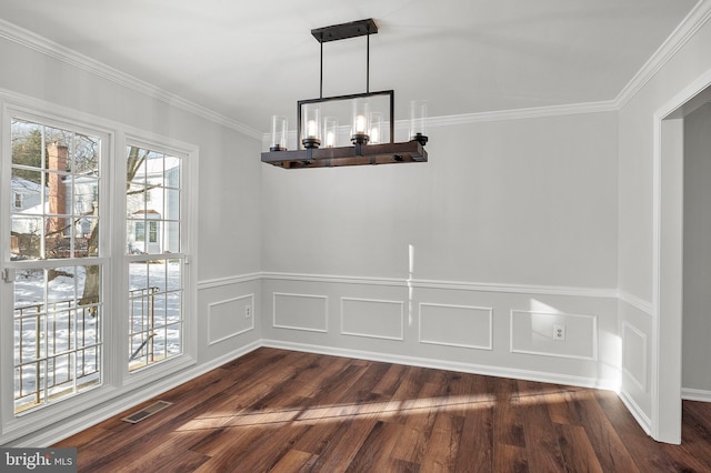 unfurnished dining area with a notable chandelier, dark wood-type flooring, and crown molding