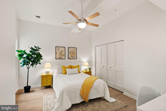 bedroom featuring ceiling fan, a closet, and light hardwood / wood-style flooring