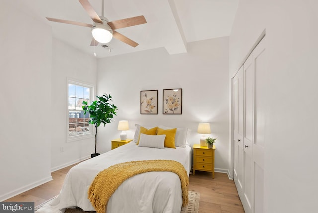 bedroom featuring ceiling fan, light hardwood / wood-style floors, and a closet