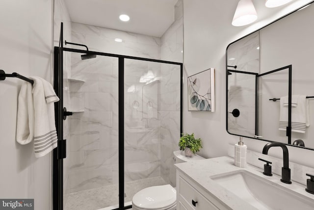 bathroom featuring toilet, vanity, and walk in shower